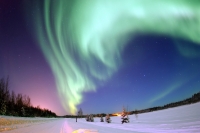 EIELSON AIR FORCE BASE, Alaska -- The Aurora Borealis, or Northern Lights, shines above Bear Lake here Jan. 18. The lights are the result of solar particles colliding with gases in Earth's atmosphere. Early Eskimos and Indians believed different legends about the Northern Lights, such as they were the souls of animals dancing in the sky or the souls of fallen enemies trying to rise again.  (U.S. Air Force photo by Senior Airman Joshua Strang)