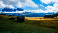 Seen while walking on the Alpe Di Siusi.   

Thanks to the play of light and shadows -  this felt like a peaceful scene from a fantasy story or fantasy world, with someone returning home by the last of the day's light.